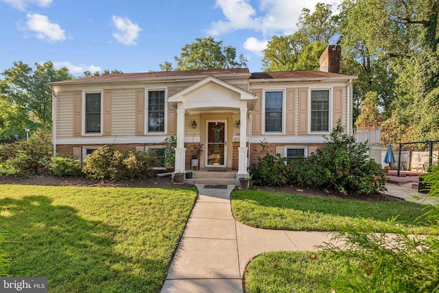 raised ranch with a front yard