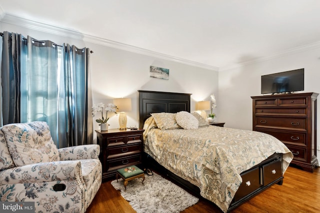 bedroom with crown molding and wood-type flooring