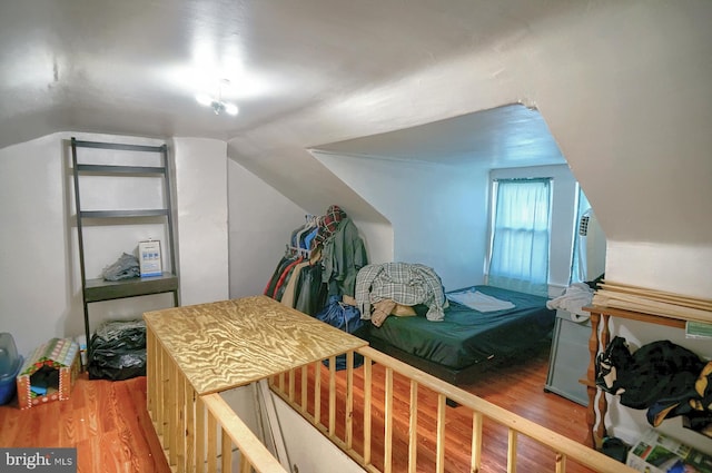 bedroom featuring vaulted ceiling and hardwood / wood-style flooring