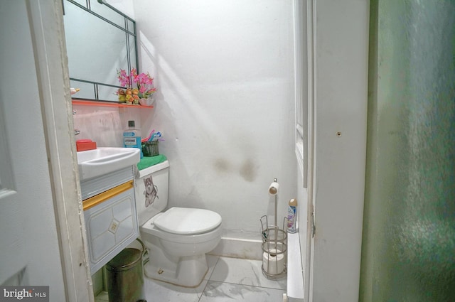 bathroom featuring tile patterned floors, toilet, and vanity