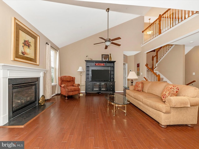 living room with high vaulted ceiling, ceiling fan, and hardwood / wood-style floors