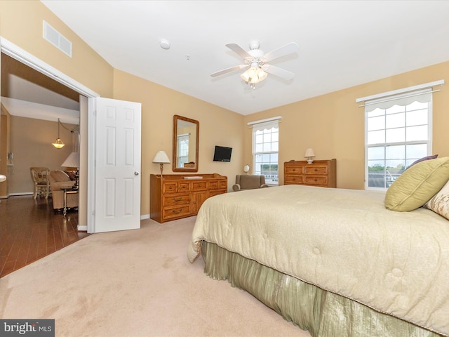 bedroom with hardwood / wood-style floors and ceiling fan