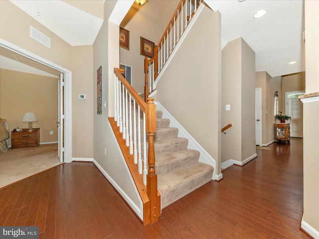 stairway with hardwood / wood-style floors