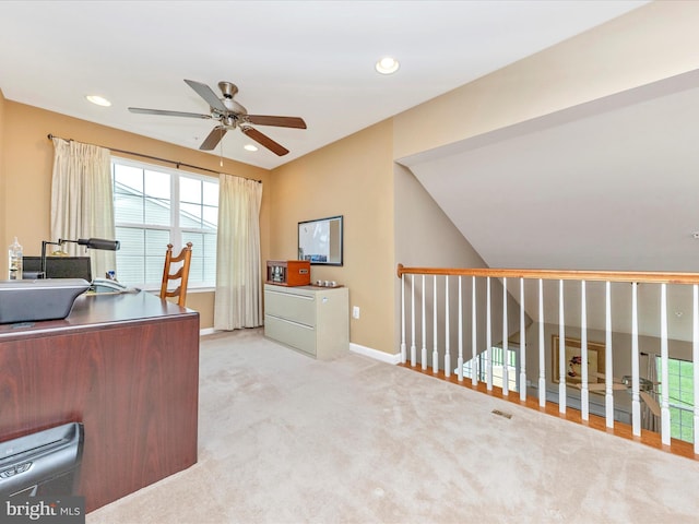 office area featuring lofted ceiling, ceiling fan, and light colored carpet