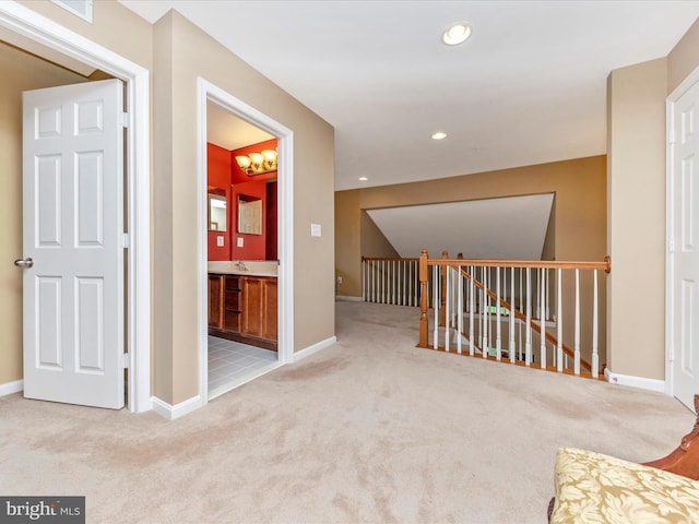 hallway featuring light colored carpet