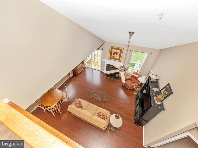 living room featuring wood-type flooring and lofted ceiling