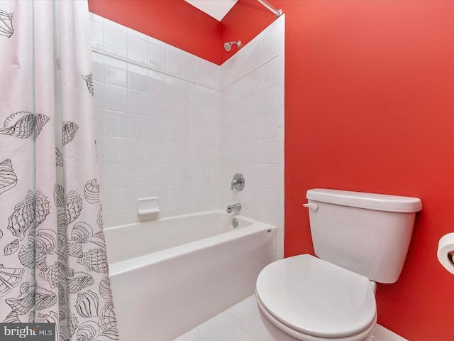 bathroom featuring shower / bath combination with curtain, tile patterned flooring, and toilet