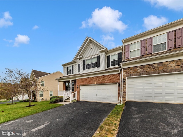 view of front of property featuring a garage and a front lawn