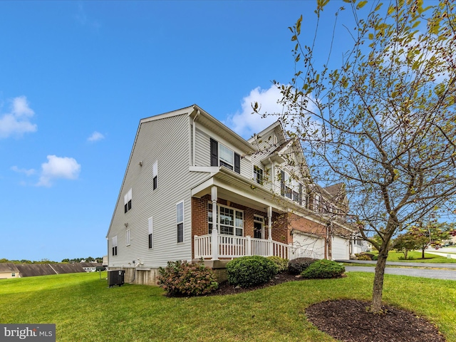 view of front of home featuring a front lawn, a porch, and central air condition unit