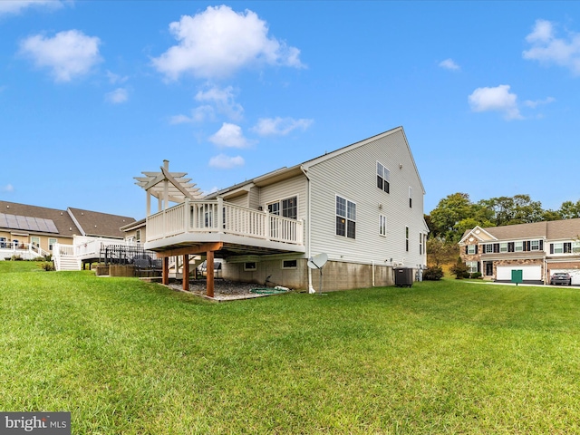 rear view of house with a lawn, central AC, a deck, and a garage