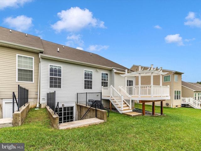 back of property featuring a deck, a yard, and a pergola