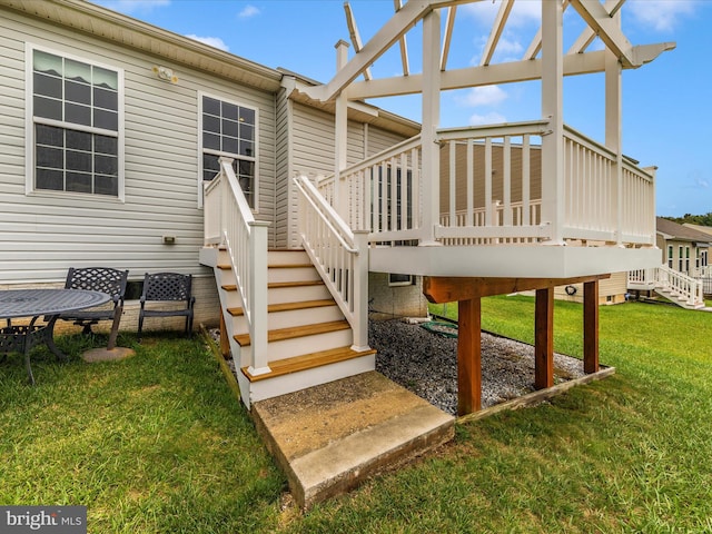 exterior space with a pergola, a wooden deck, and a lawn