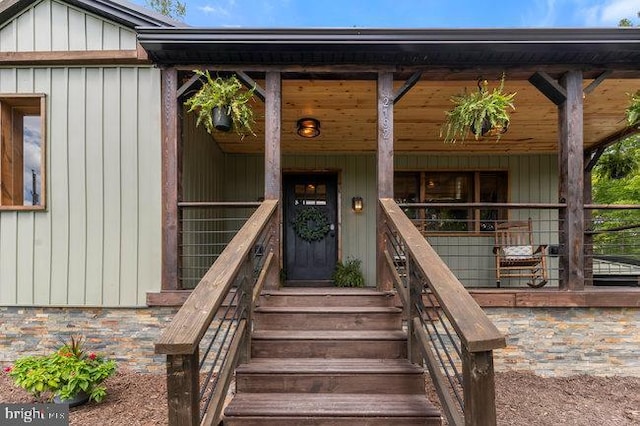 view of exterior entry featuring covered porch