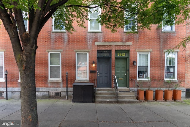 view of front of property with entry steps and brick siding