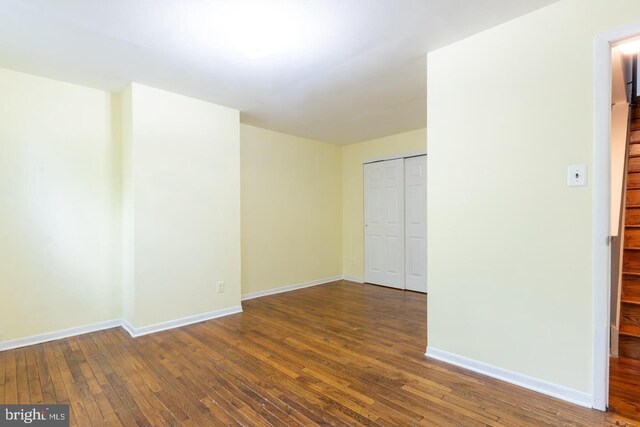 spare room featuring wood-type flooring