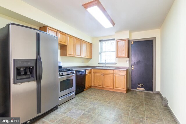 kitchen featuring sink, stainless steel appliances, and tile patterned floors