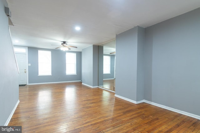 spare room featuring baseboards, a ceiling fan, and wood finished floors