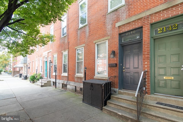 entrance to property with brick siding