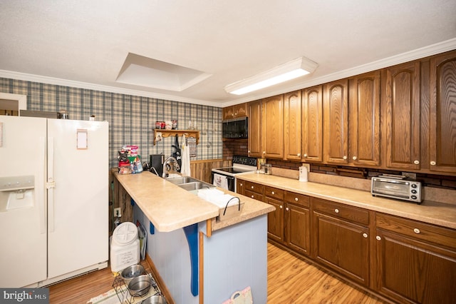 kitchen featuring a kitchen bar, sink, white fridge with ice dispenser, light hardwood / wood-style floors, and range with electric cooktop