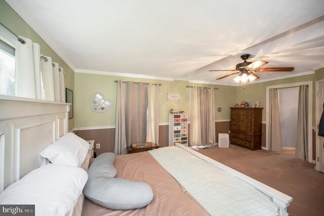 bedroom featuring ceiling fan, carpet, and ornamental molding