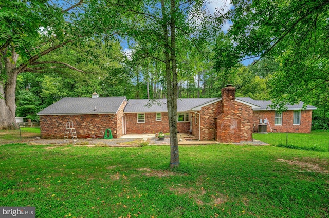 back of house featuring a patio area, central AC unit, and a lawn