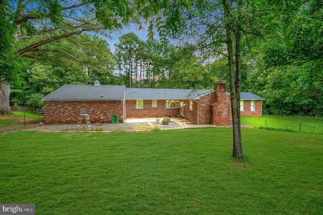 rear view of property with a patio and a yard