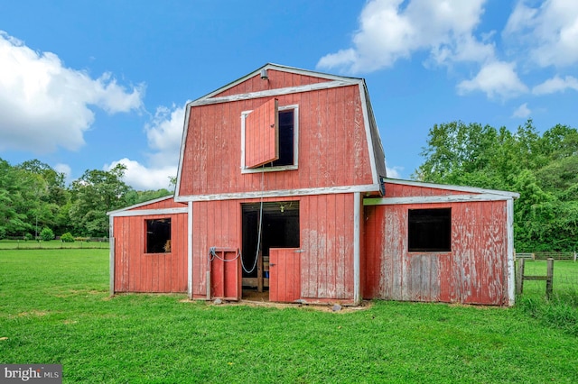 view of outdoor structure featuring a lawn