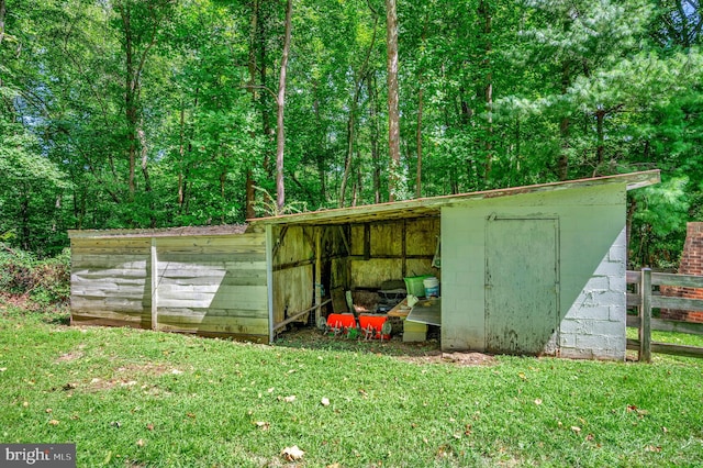 view of outbuilding with a lawn