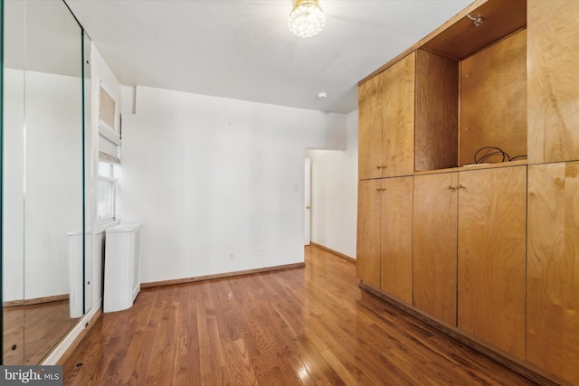 unfurnished bedroom featuring hardwood / wood-style flooring