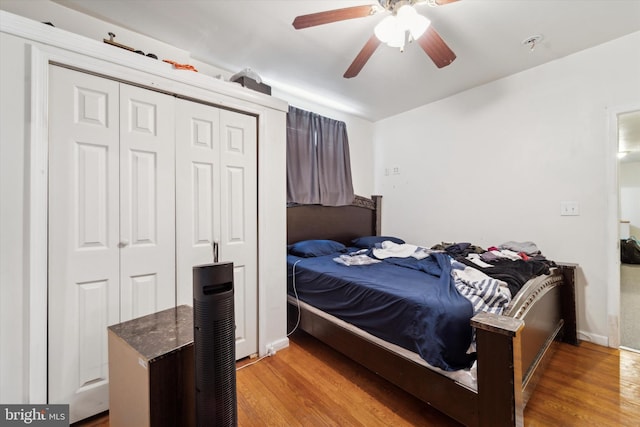 bedroom with light wood-type flooring, a closet, and ceiling fan