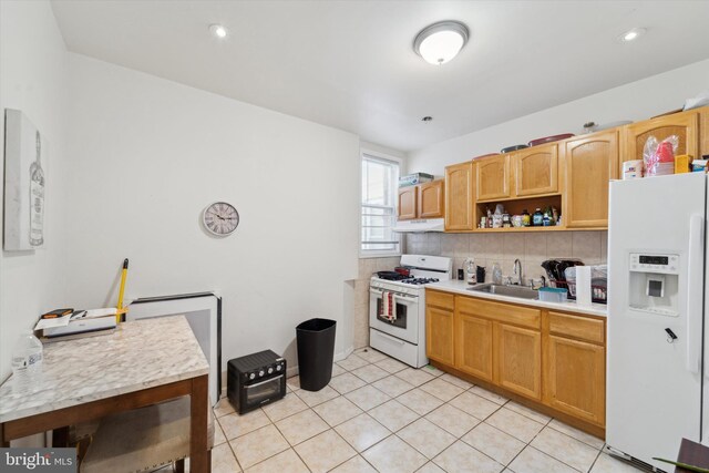 kitchen featuring light tile patterned floors, white appliances, backsplash, and sink