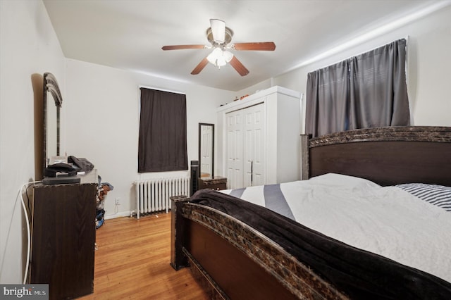 bedroom featuring hardwood / wood-style flooring, ceiling fan, and radiator heating unit