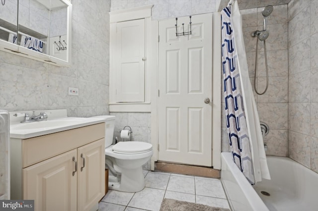 full bathroom with vanity, shower / bathtub combination with curtain, tile walls, tile patterned flooring, and toilet