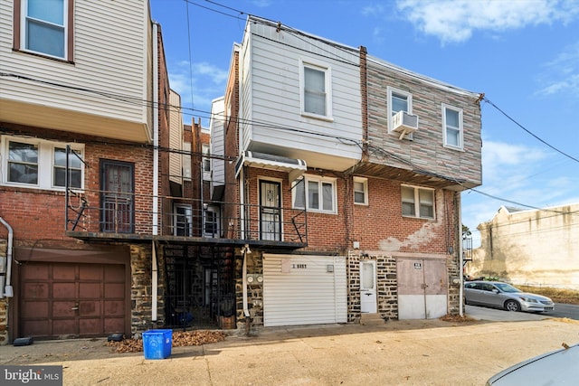 view of front of home featuring a balcony and cooling unit