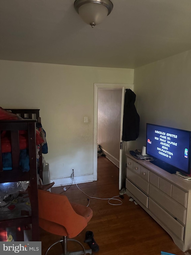 bedroom with dark hardwood / wood-style floors