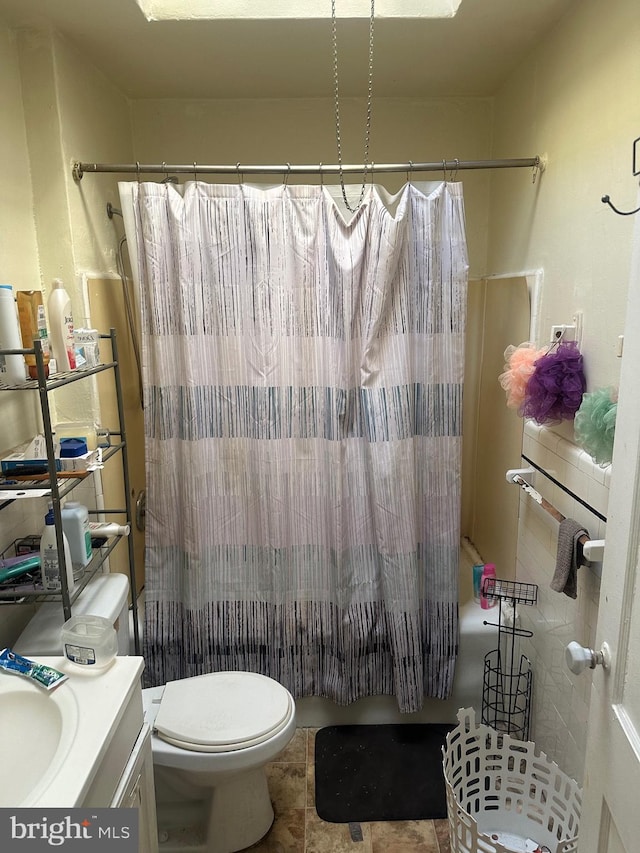 full bathroom with vanity, toilet, tile patterned floors, and shower / tub combo with curtain