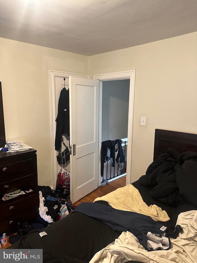 bedroom with a closet and hardwood / wood-style flooring