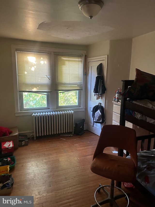 interior space with hardwood / wood-style floors and radiator