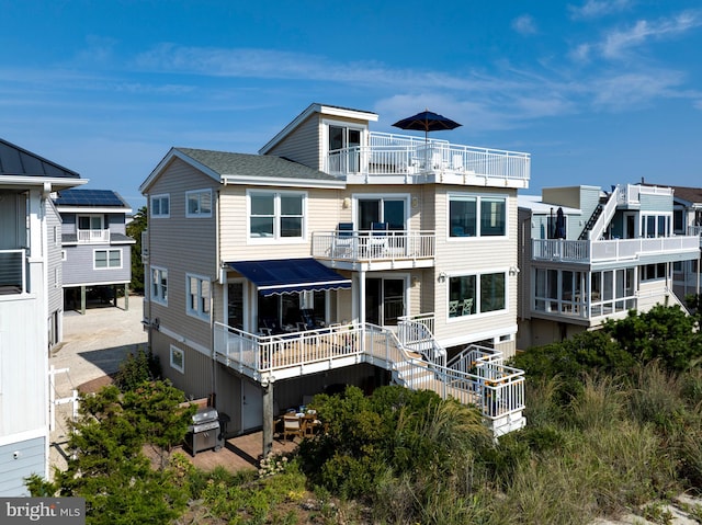 back of property featuring a balcony