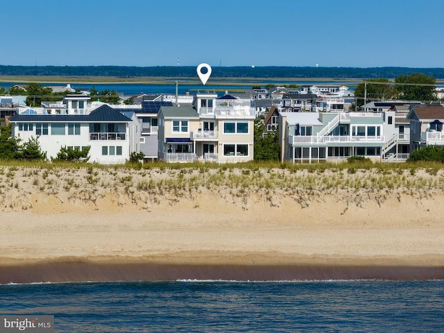 aerial view with a water view, a residential view, and a view of the beach