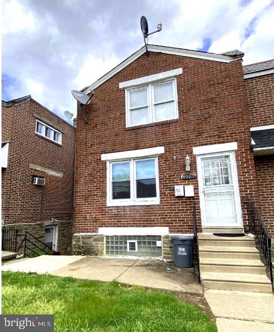 view of front of home featuring entry steps and brick siding