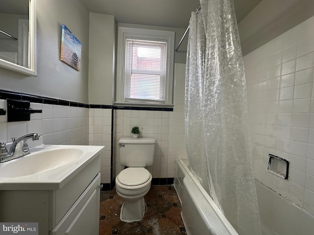 full bath featuring toilet, shower / bath combination with curtain, tile walls, and vanity