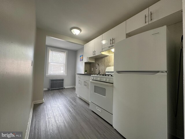 kitchen featuring light hardwood / wood-style flooring, backsplash, radiator, white cabinets, and white appliances