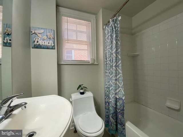 full bathroom featuring shower / tub combo, a sink, and toilet