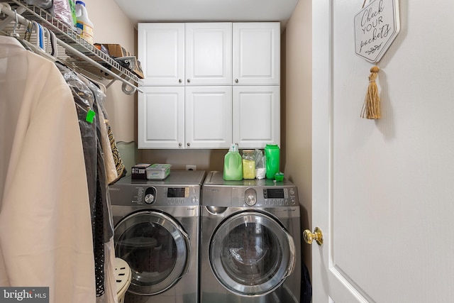 washroom with cabinet space and separate washer and dryer