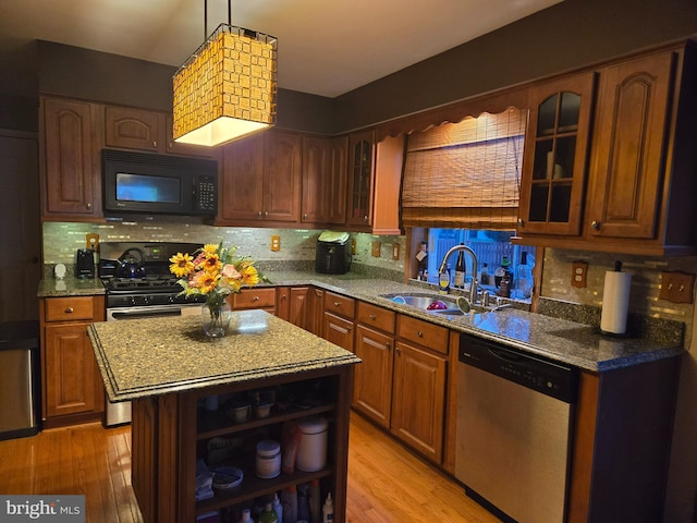 kitchen with black microwave, stainless steel dishwasher, brown cabinets, open shelves, and glass insert cabinets