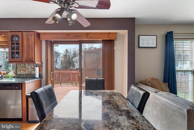 dining area featuring a ceiling fan and light wood finished floors