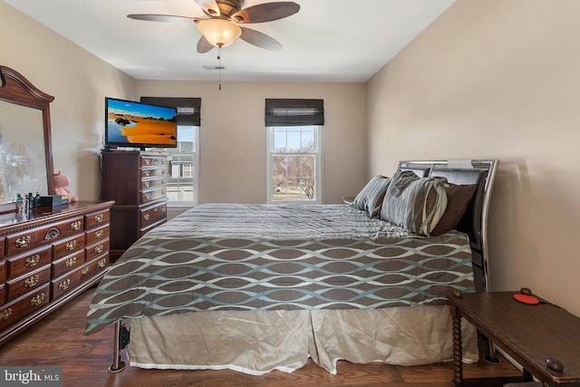 bedroom with ceiling fan and dark wood-type flooring