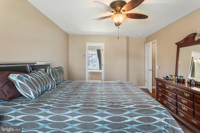 bedroom featuring a ceiling fan, baseboards, and ensuite bath