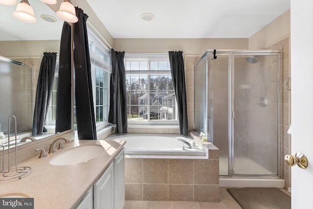 bathroom featuring a garden tub, a shower stall, tile patterned flooring, and vanity